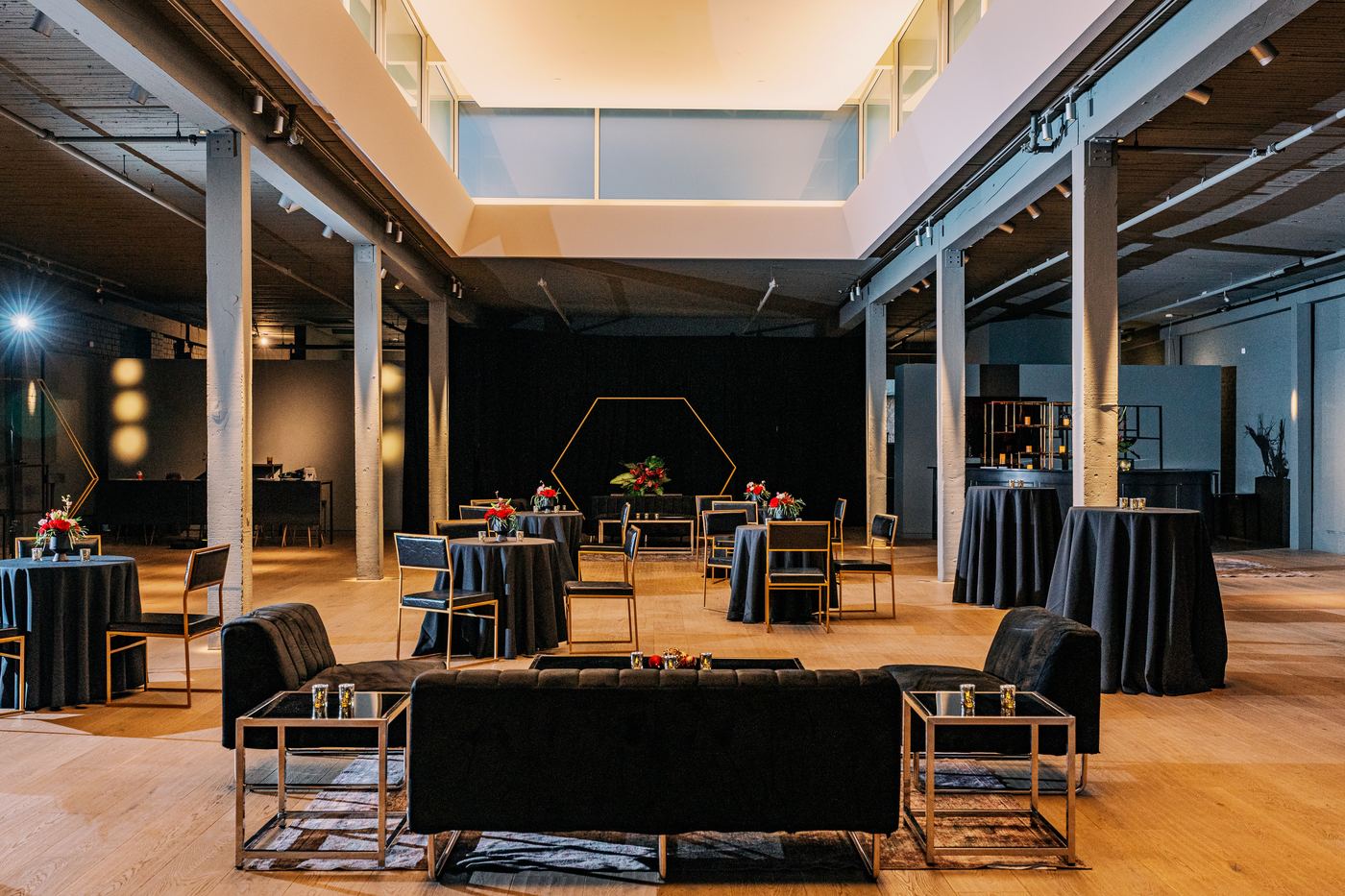 Palladian Arthouse 5,000 sq ft event hall in cocktail reception setup with lounge seating and hexagon arch backdrop