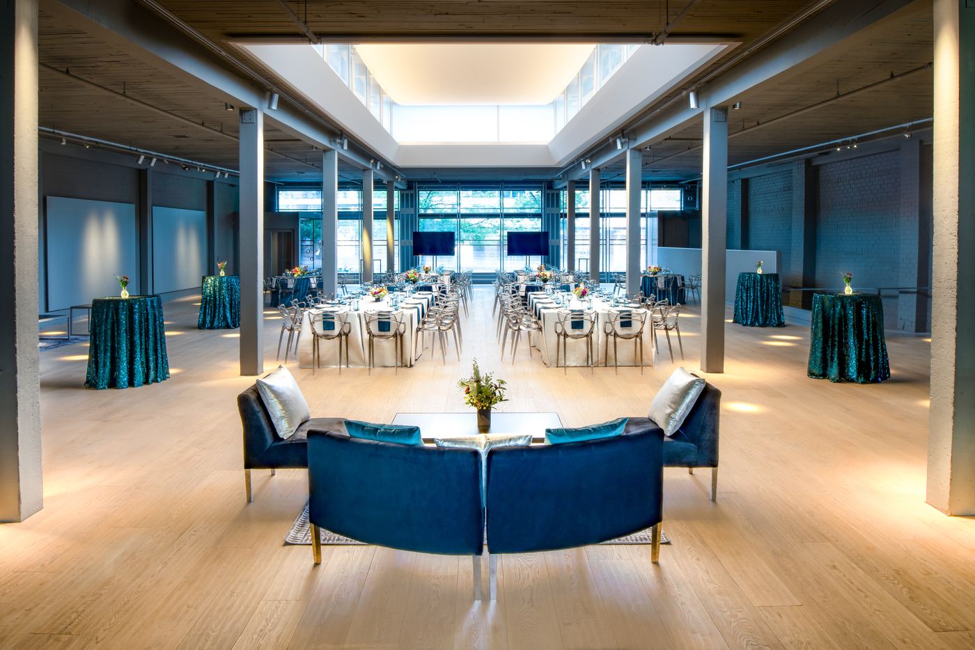 Palladian Arthouse event hall with long banquet tables and teal sequin accent tables for a seated dinner