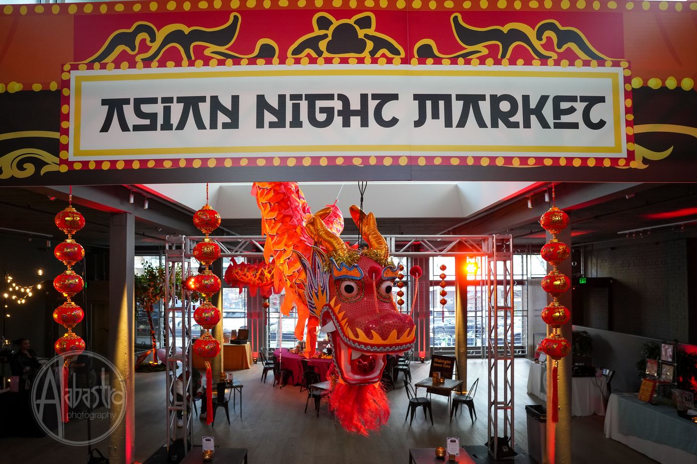 Custom Asian Night Market event decor at Palladian Arthouse Belltown Seattle with dragon sculpture and red lanterns
