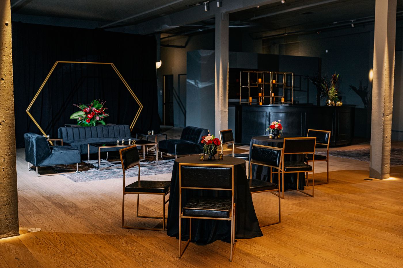 Palladian Arthouse cocktail reception with gold hexagon arch ceremony backdrop and velvet lounge seating